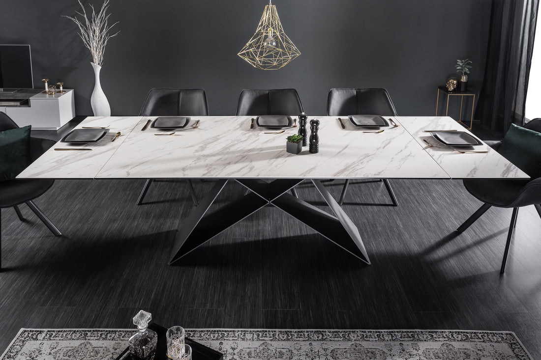Modern extendable dining table with marble-look ceramic top and geometric metal base, set for six